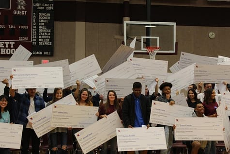 NMSI students receive check for passing their AP test in English, math, or science during a pep rally that celebrates their academic success. 